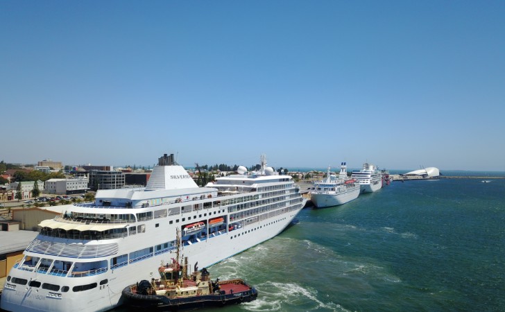 cruise ships entering Fremantle Port under clear blue sky