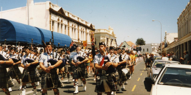 people wearing kilts march down Fremantle's Cappuccino Strip 