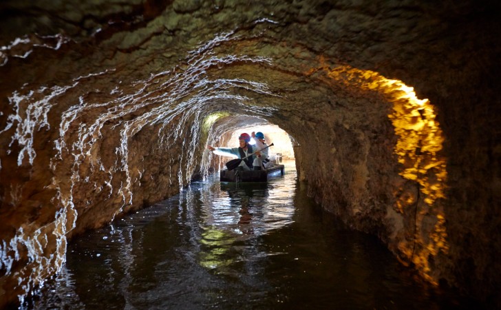 people paddle a kayak through historic tunnels at Fremantle Prison