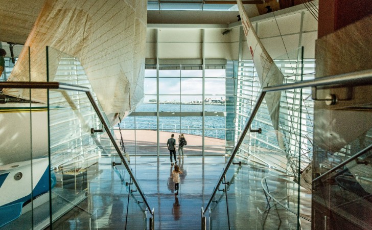 family looks out to ocean from huge maritime museum