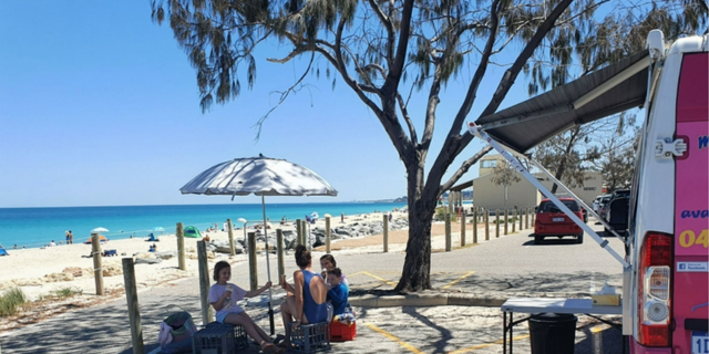 family enjoying ice cream from the pink van at port beach in fremantle