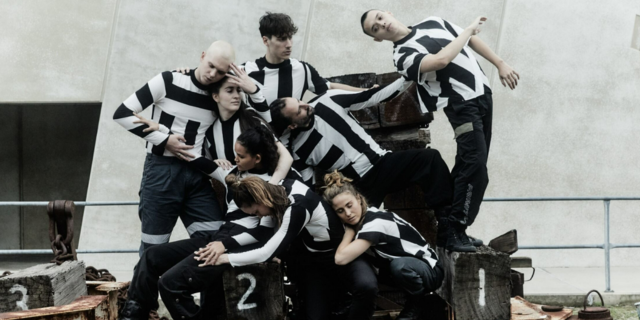 people wearing black and white striped clothes weave their bodies together in front of white background for cease fire at fremantle biennale