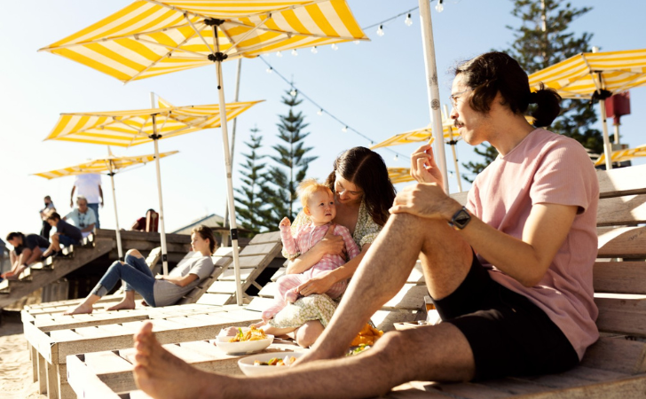 Family at Bather's Beach enjoying fish n chips