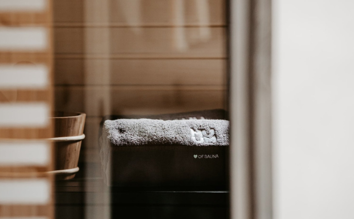 fluffy towel and wooden sauna bucket through spa windows