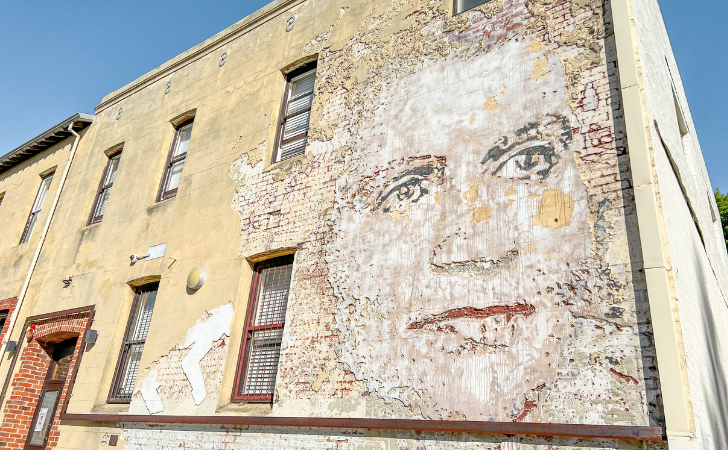 Face of Dame Dorothy Tangney carved into building wall
