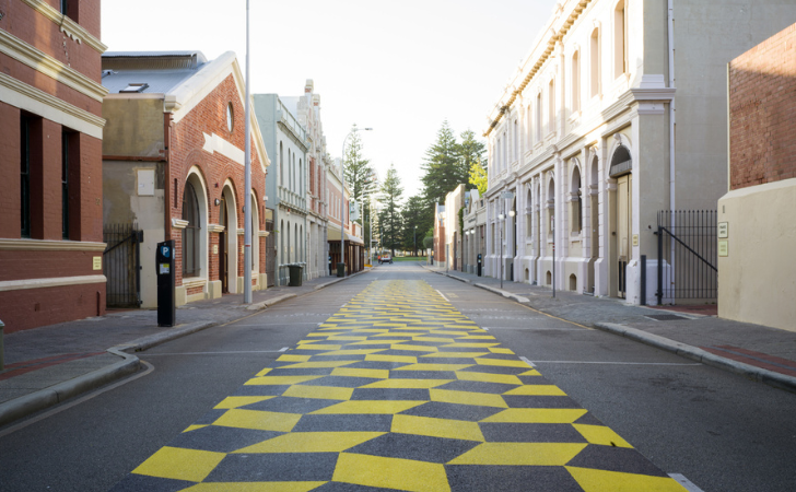 yellow graphic shapes on black road disrupts the way we view Fremantle's historic West End
