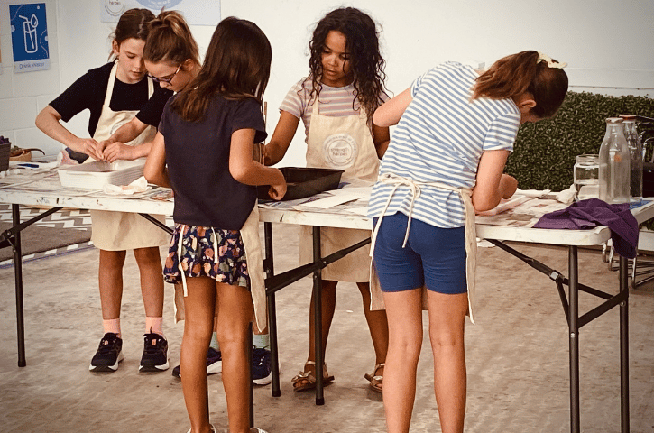 kids leaning over a fold out table doing crafts in Fremantle, WA 