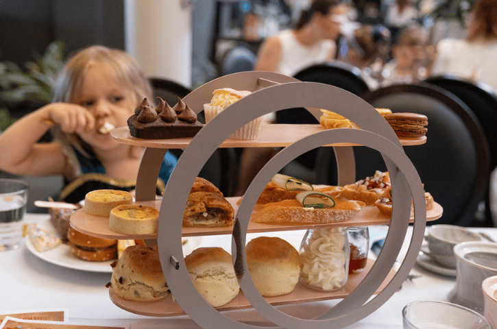 a child eating from a big tea tray at the Esplanade Hotel in Fremantle, WA 