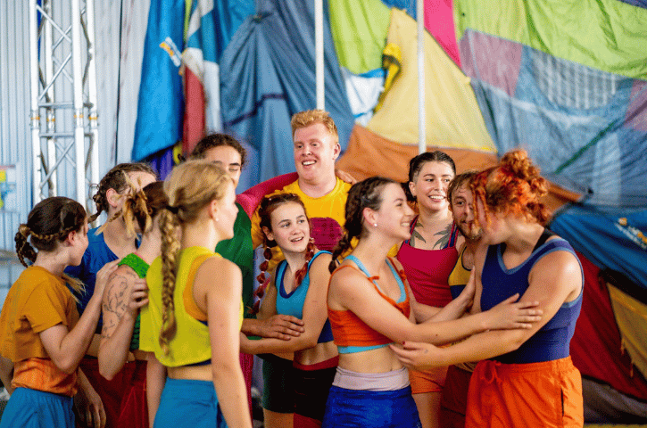 kids in bright clothing cheering together 