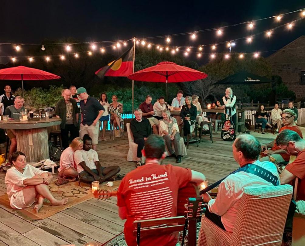 people listening to music outdoors at night