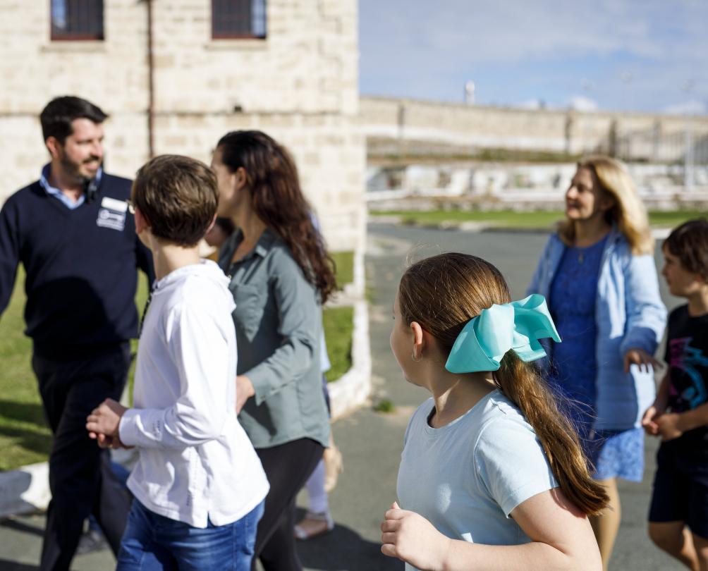Tour guide taking families around the Fremantle Prison 