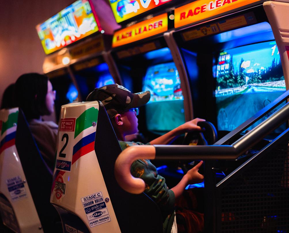 The Palace Arcade - kids playing vintage arcade driving games