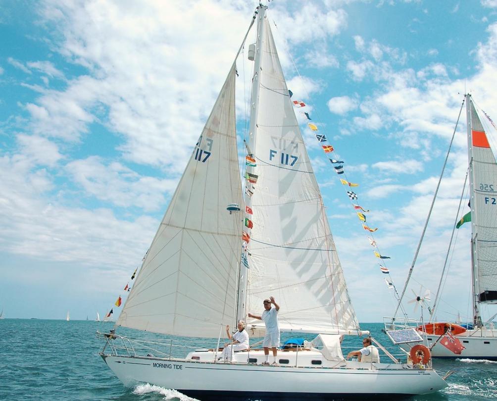 yacht with colourful flags sailing in the ocean. 