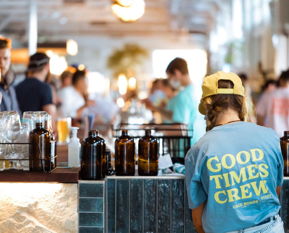 Photo of inside of venue over the shoulder of a bar person