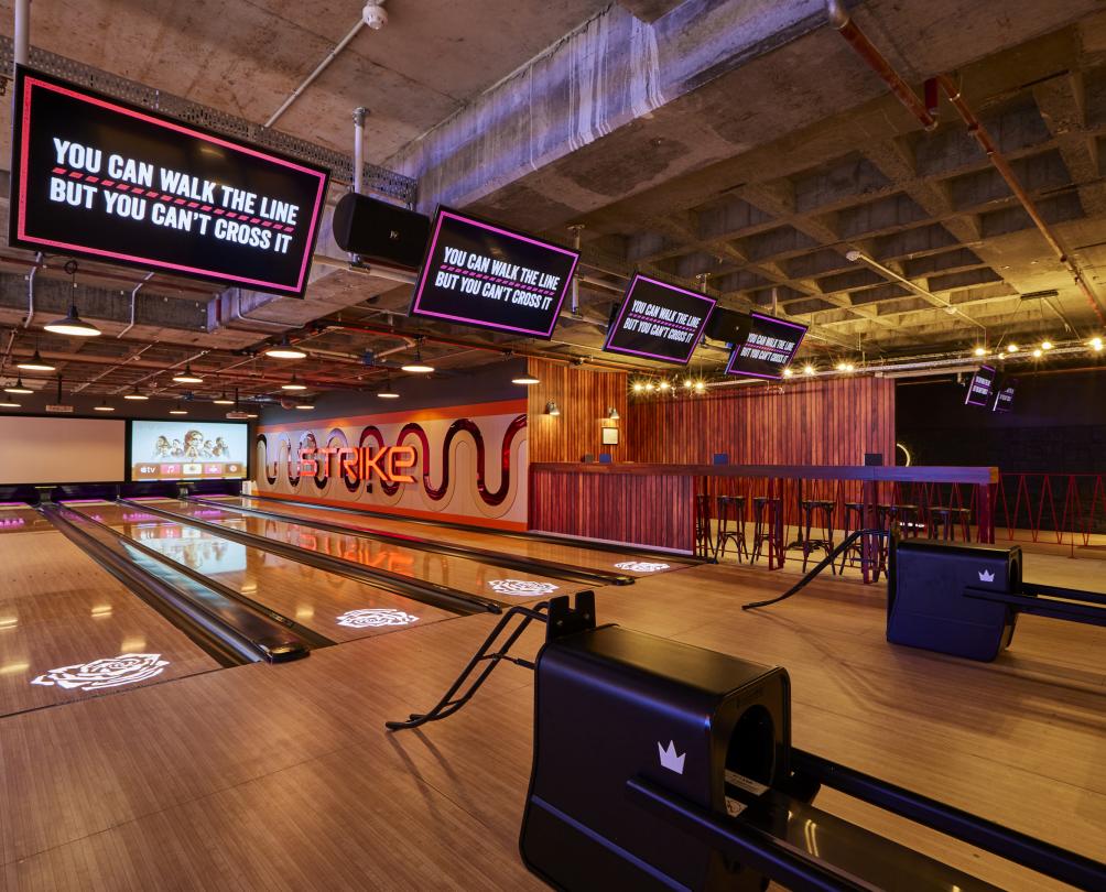 View of bowling lanes, polished wooden floors at Strike, Fremantle