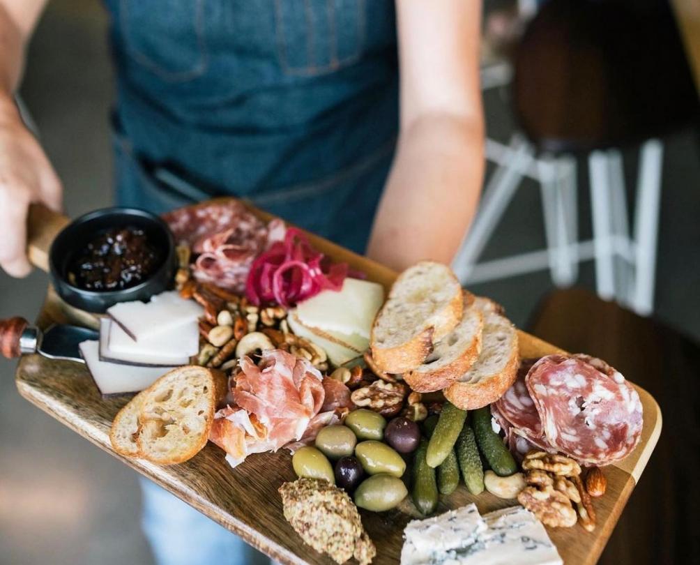 person holding a grazing platter