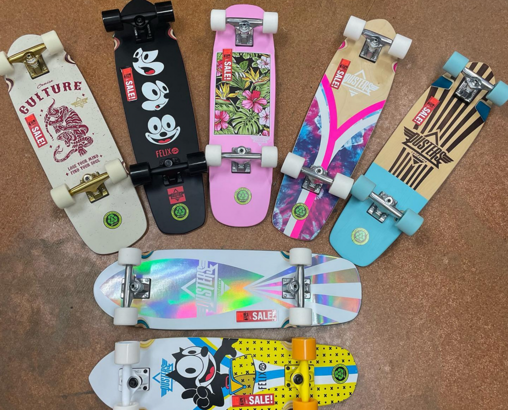 seven colourful skateboards flatlaid