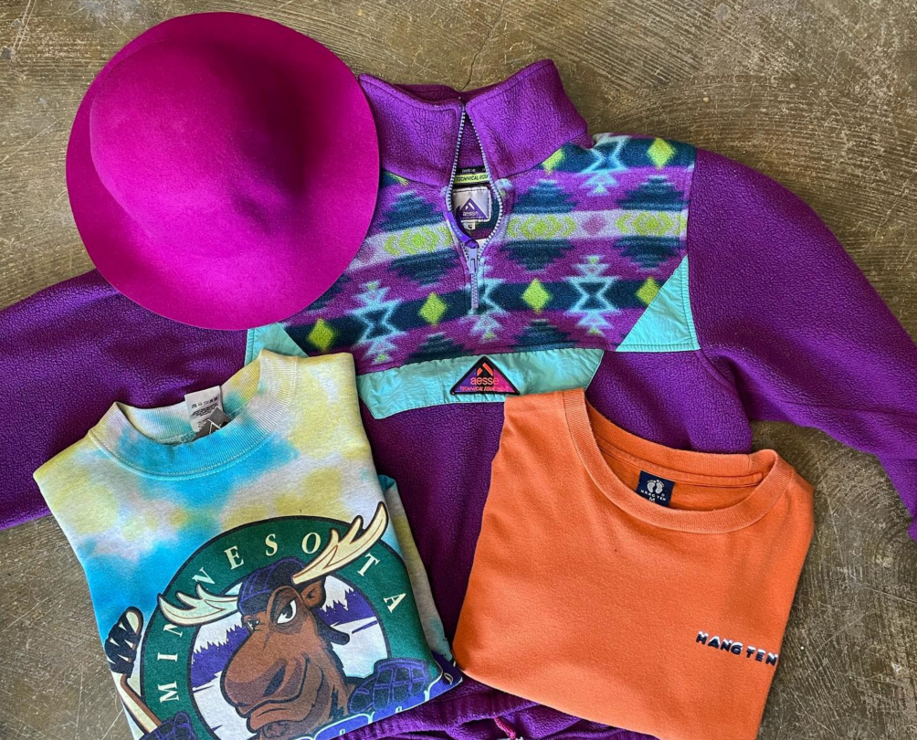 colourful hat, patterned fleece jumper, tshirts flatlaid