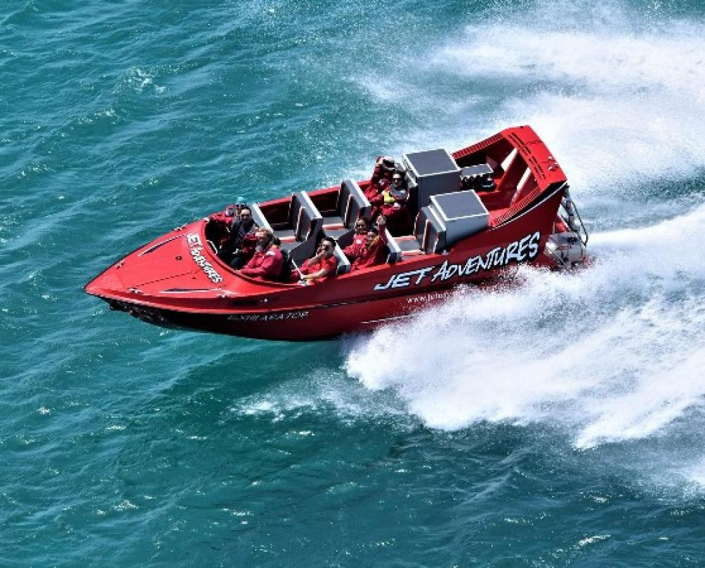 red Cicerellos Jet Adventures speed boat blasts off in turquoise waters