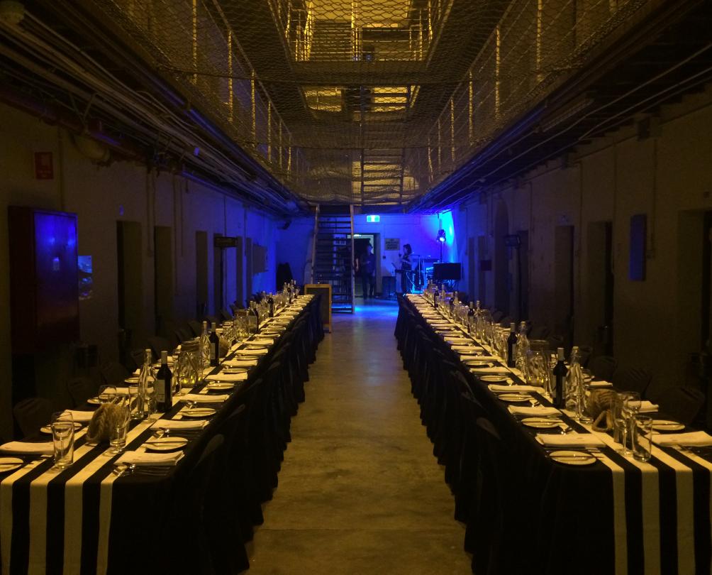 Interior of cell block set up with long tables on either side of the image