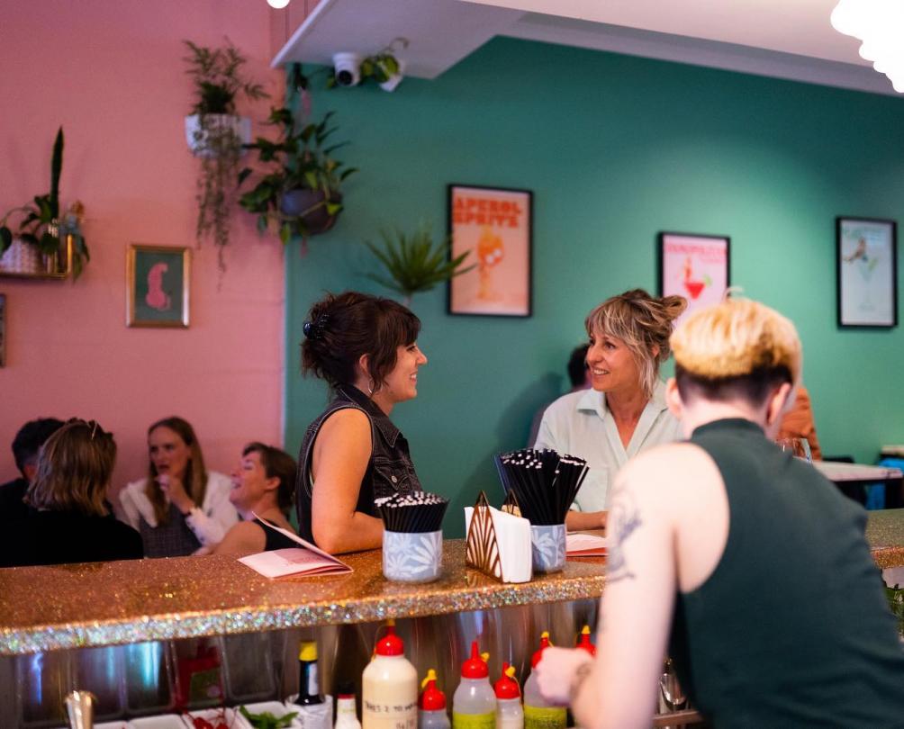 Two women sitting at the bar at The Flaming Galah