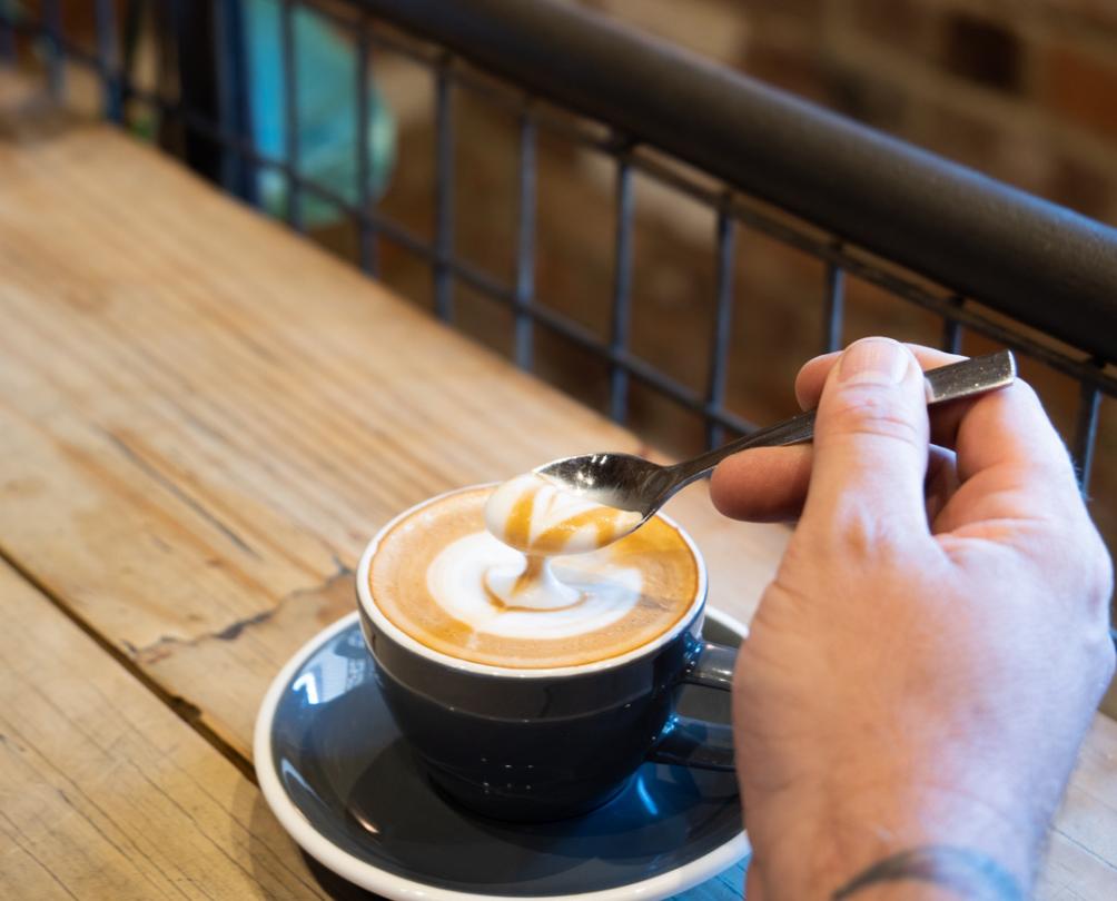 Coffee in a black cup on a wooden table 