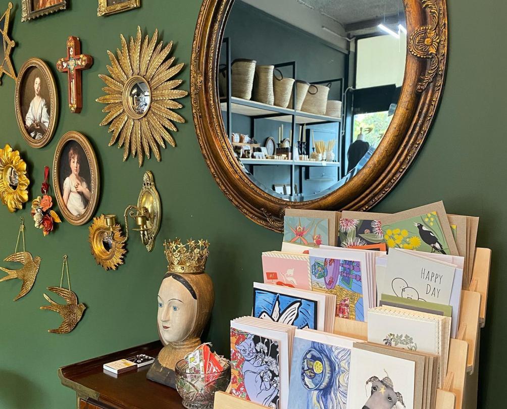 Cards and wall hangings displayed against a green wall