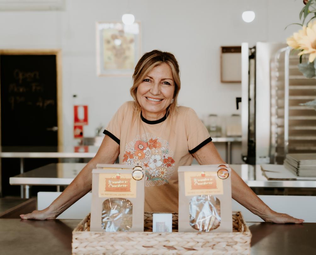 Branka behind the counter with the two bags of crackers