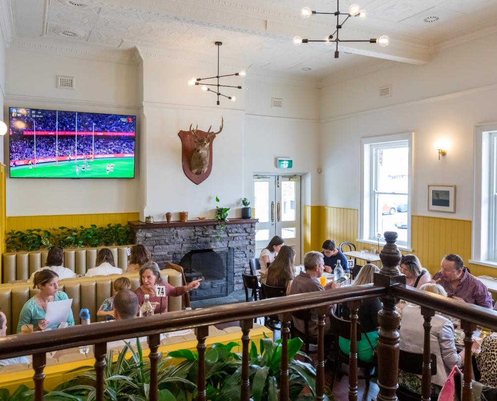 The Wray Hotel interior with tables packed with guests