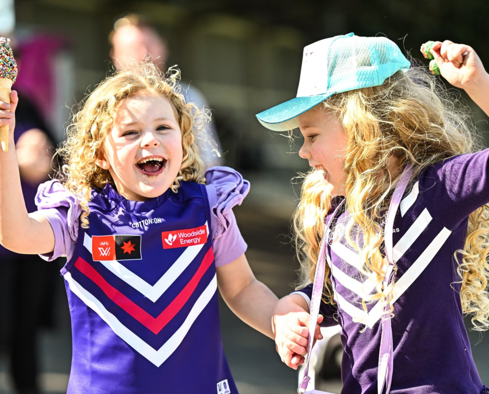 Children in AFLW Dockers tshirts holding icecream.