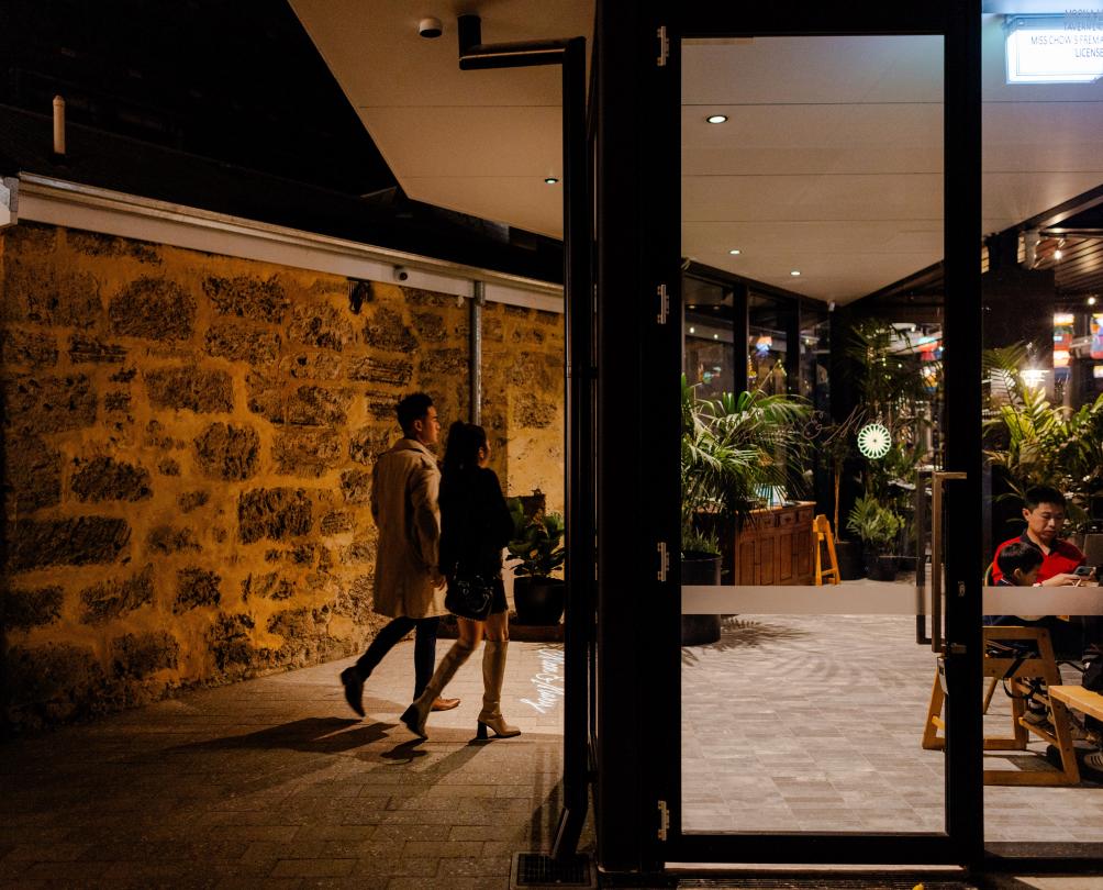 A couple walking into Moon and Mary.