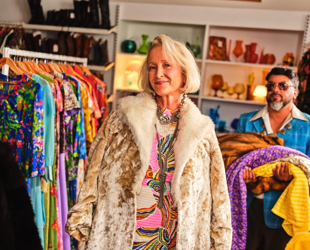 woman trying on clothes at a vintage store