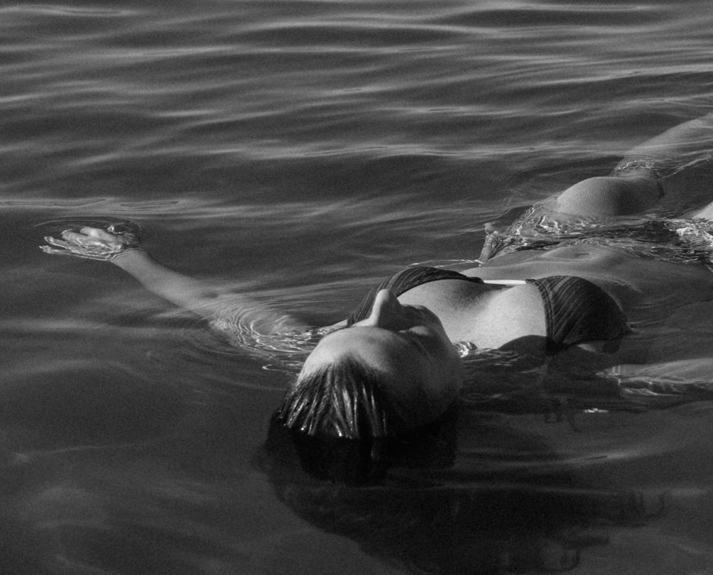 person floating in the ocean 