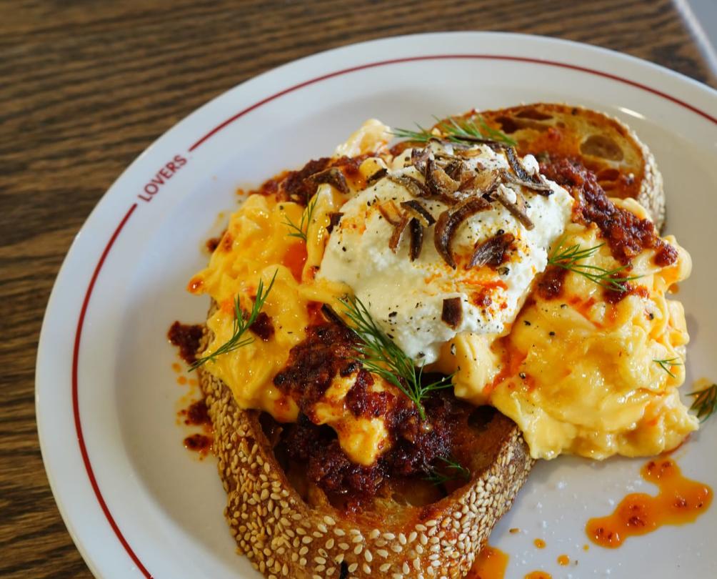 a scrambled egg plate with a white sauce and a drizzle from Lovers Canteen 