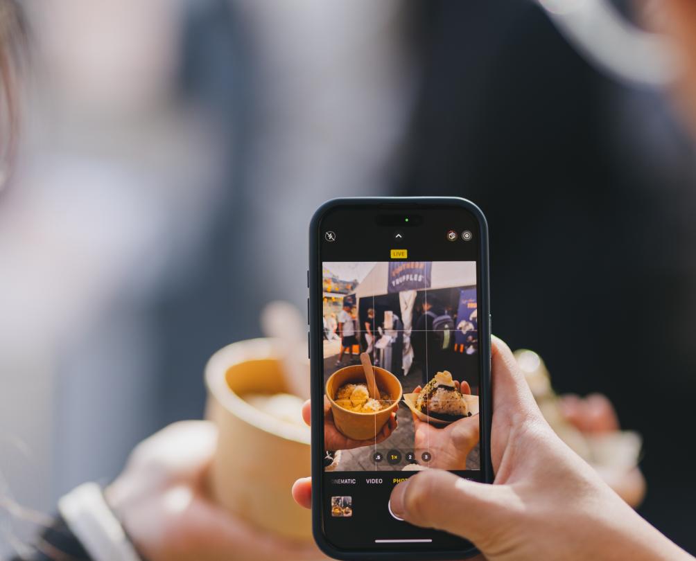 a phone taking a picture of a food offering