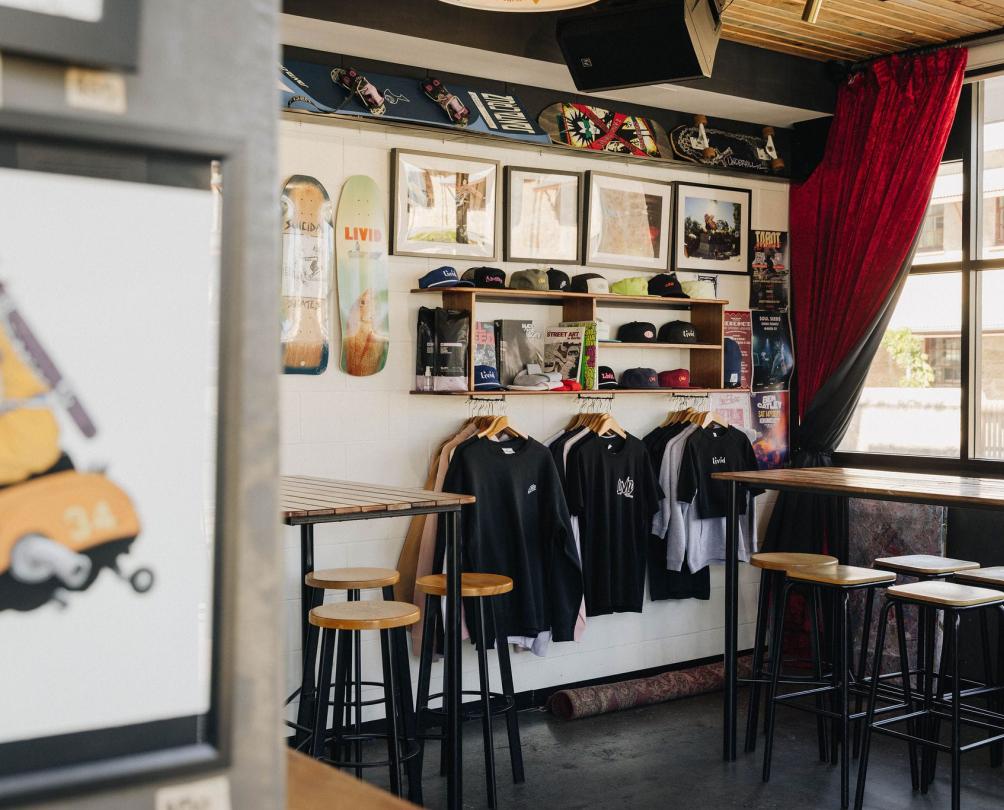 the storefont of Livid Skate with tshirts and skateboards hanging in the background