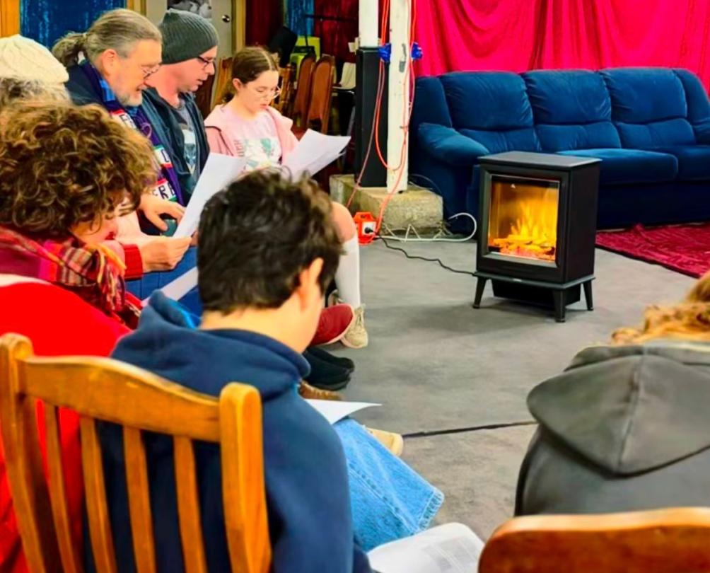 a choir sitting in a comfy living room at Penny Lane music workshop, Fremantle 