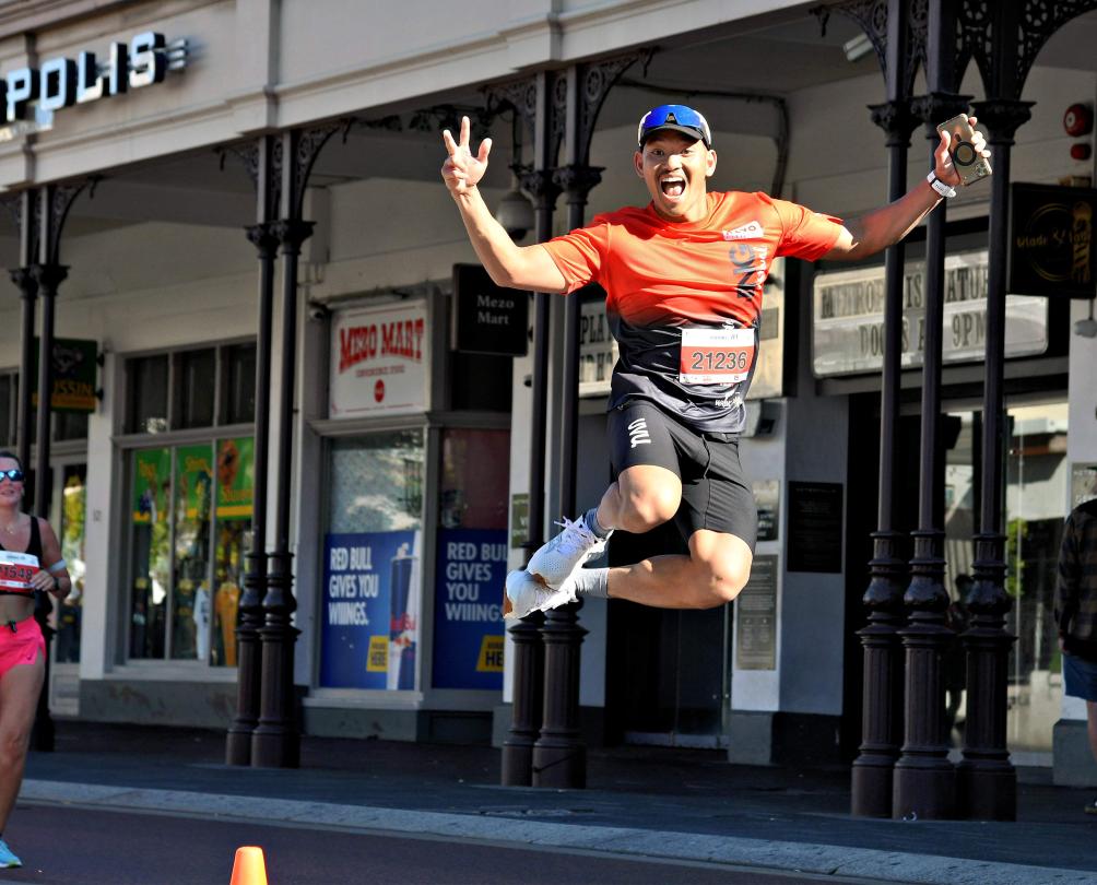 a man jumping in the street for the Fremantle Running Festival 