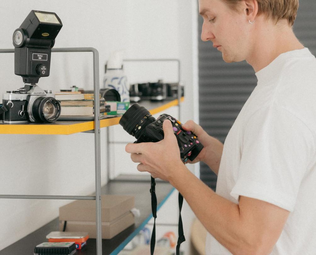 a man looking at an old camera 