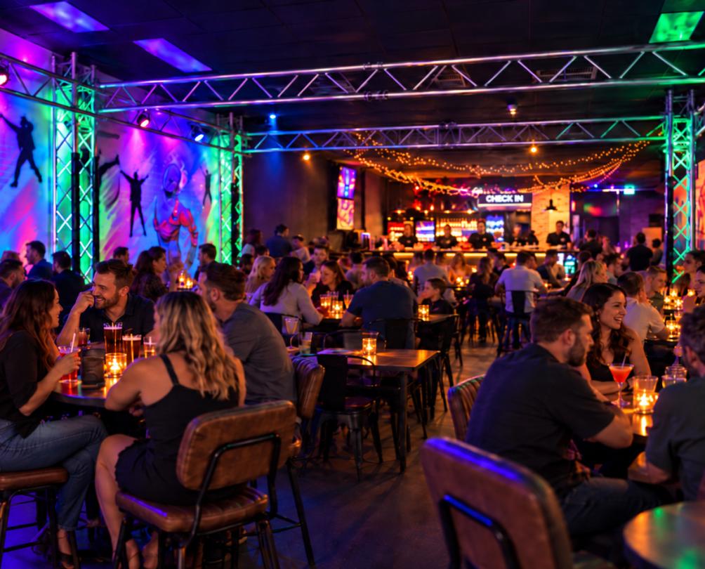 a group of people at tables in a darkly lit room