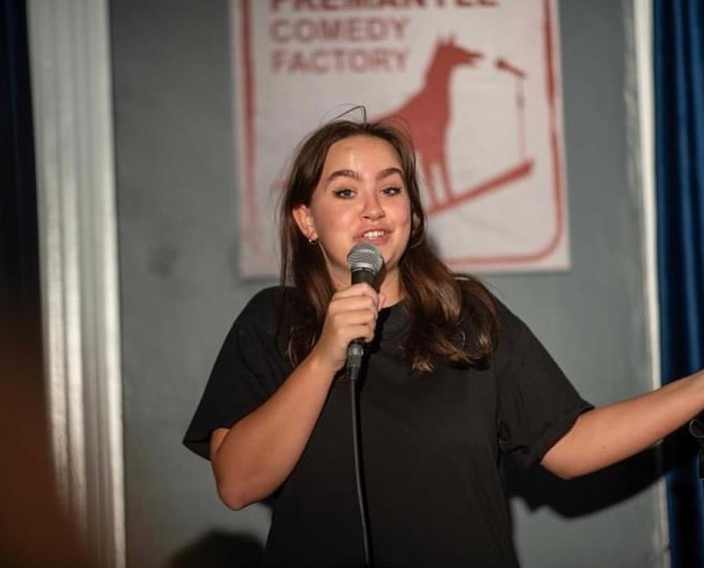 a women on a stage with a microphone