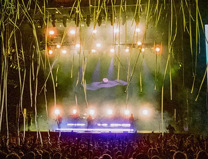 Ocean Alley perform on a stage with two big screens on either side and streamers falling on the audience.