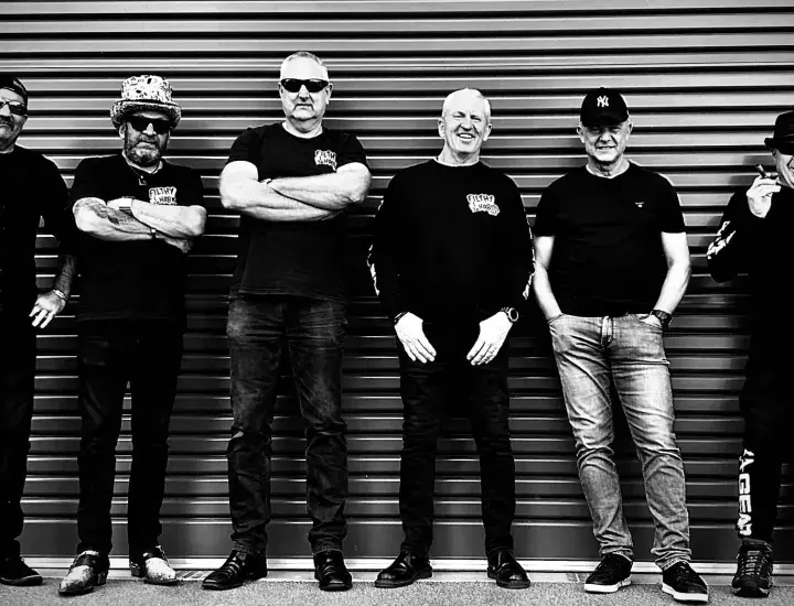 Filthy Habits – The Band members standing alone a corrugated iron wall.
