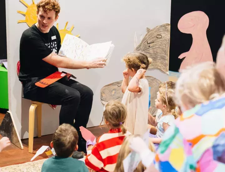 Someone reading a group of kids a story