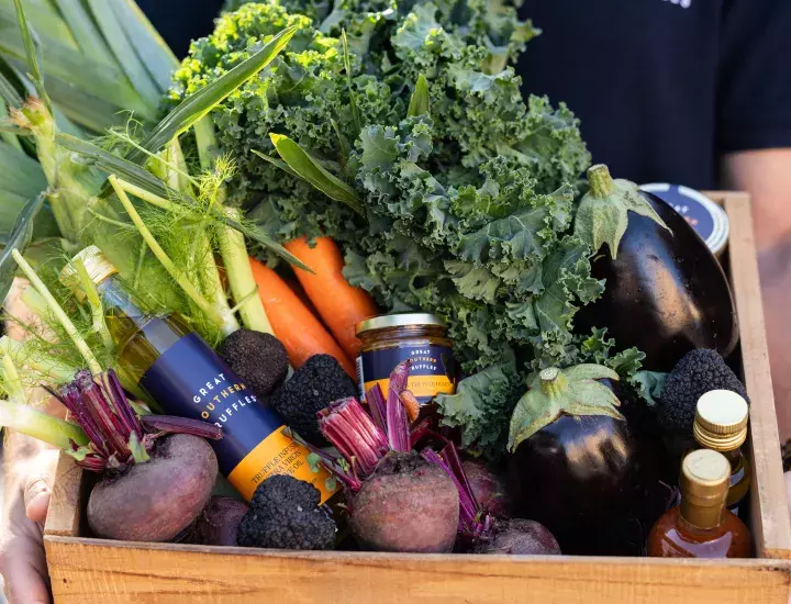 a basket of fruit and vegetables and truffle oil 
