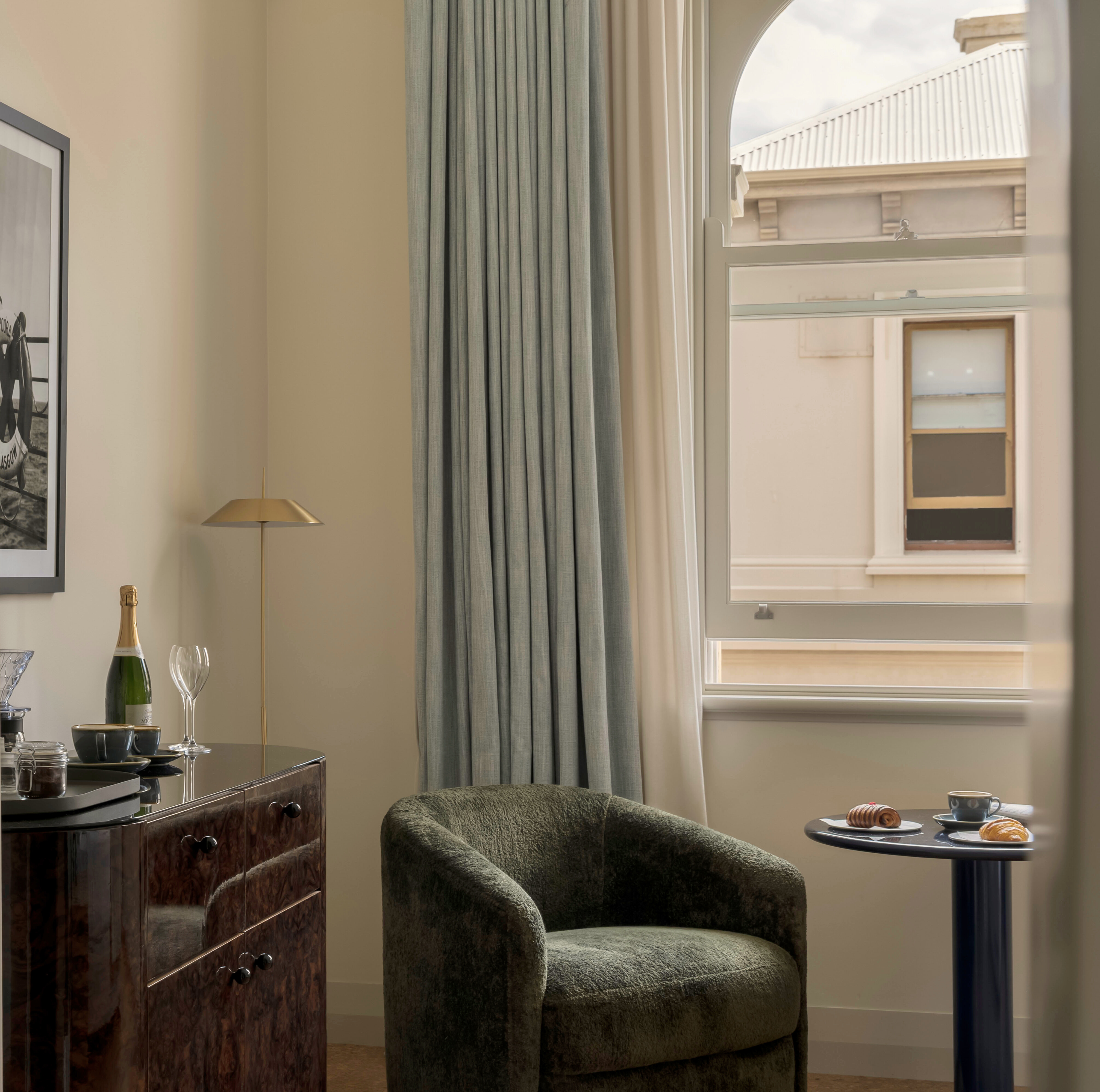 a beautiful heritage room in the Owston building with a blue curtain and lovely chair